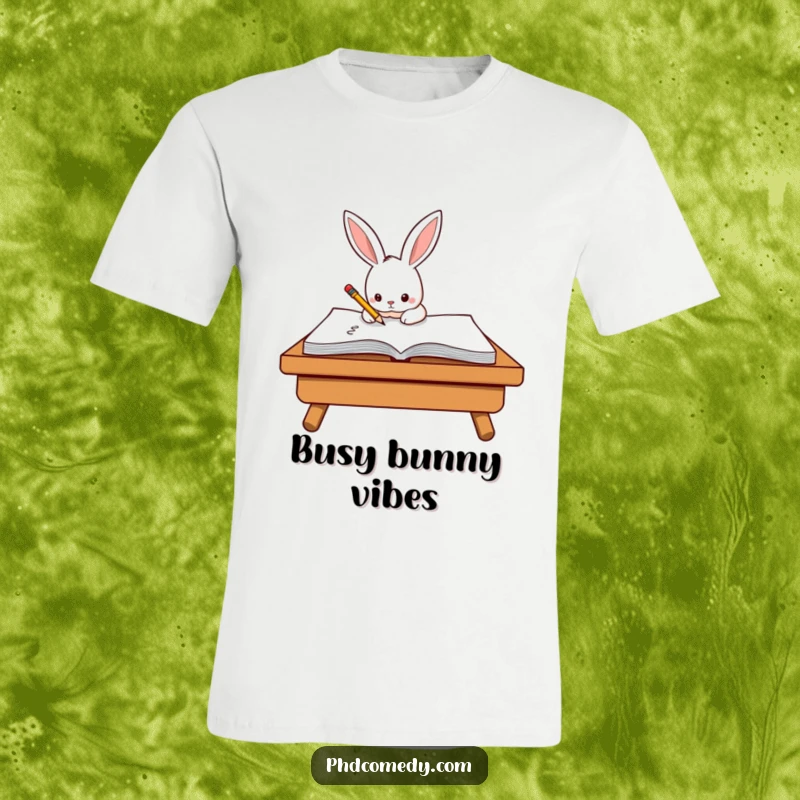 Funny determined kawaii rabbit diligently scribbling on a large notepad with a small pencil on a t-shirt.